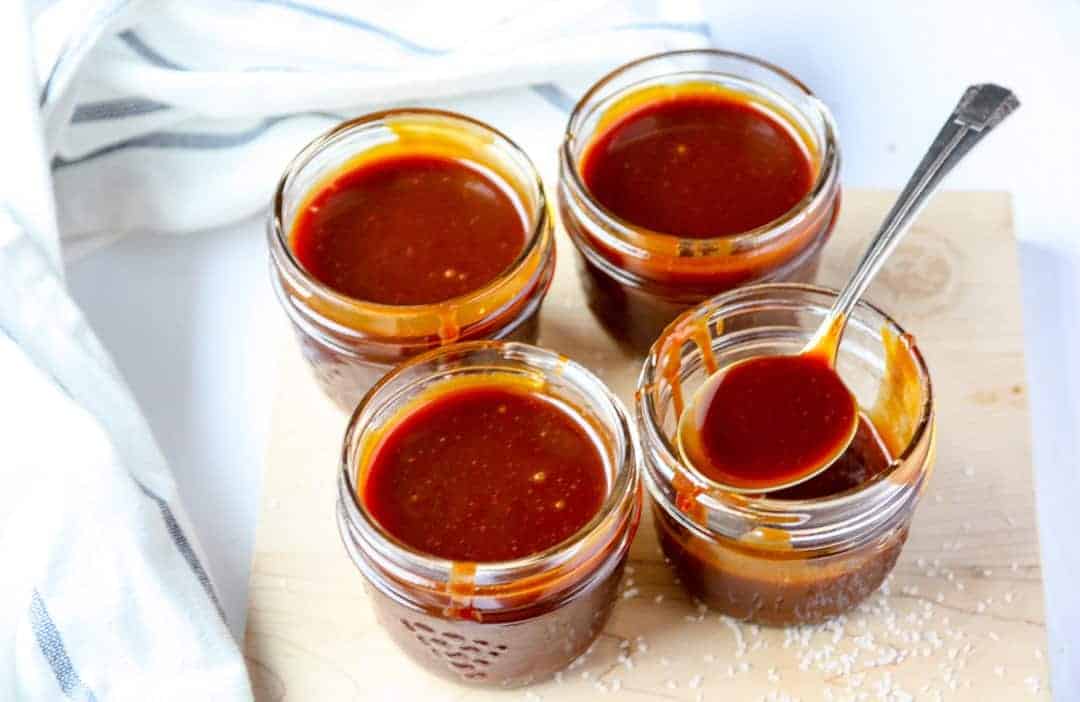 Caramel sauce in glass jars on a table