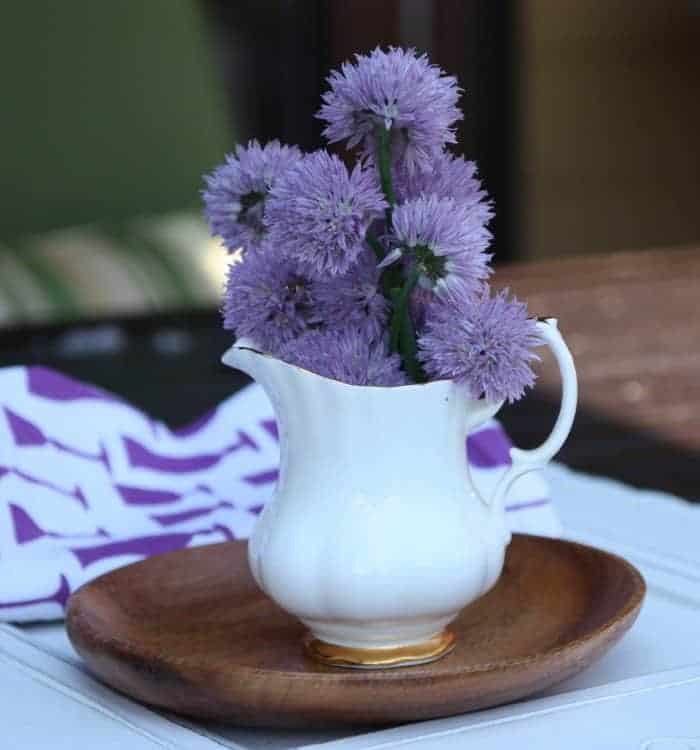 A vase filled with purple flowers on a table