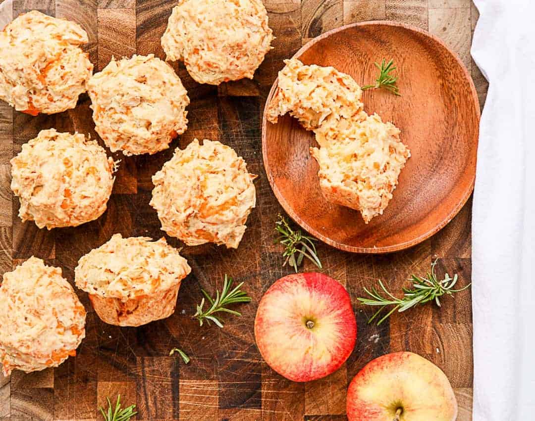 Muffins on a wooden table with apples