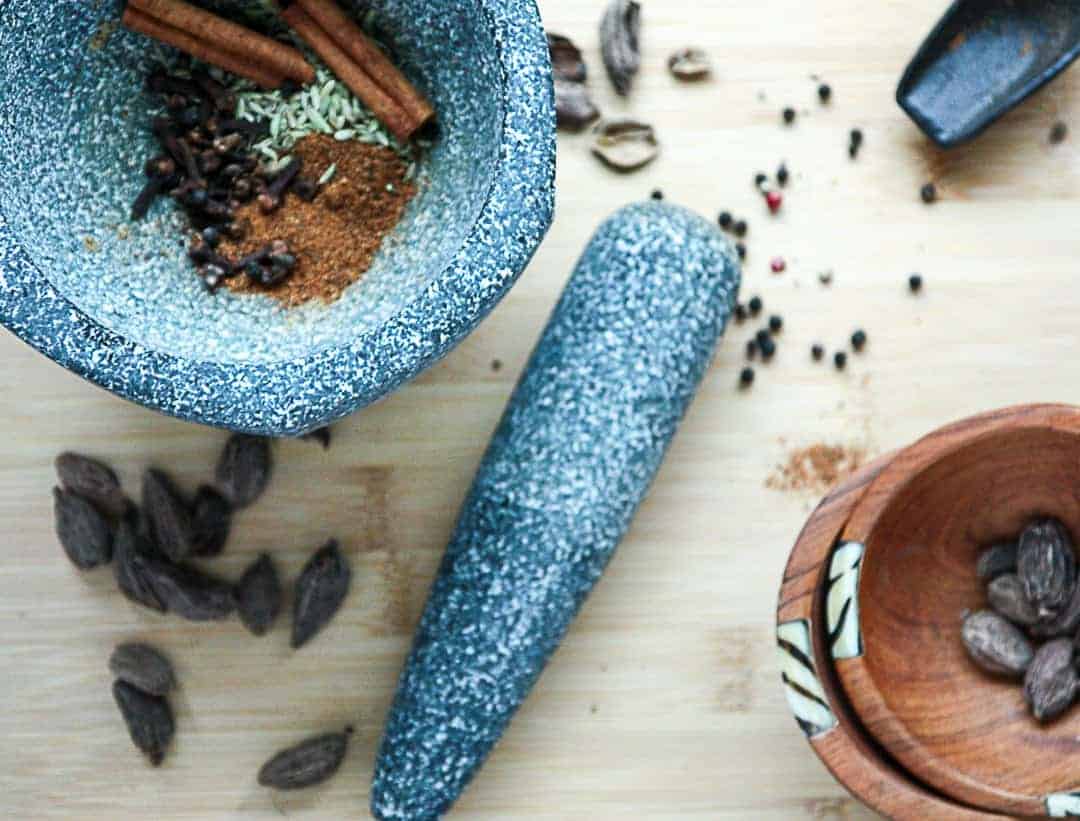 A mortar and pestle with spices ready for grinding