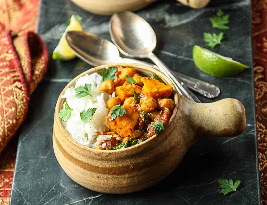 Sweet Potato Chickpea Curry with rice in a pottery bowl