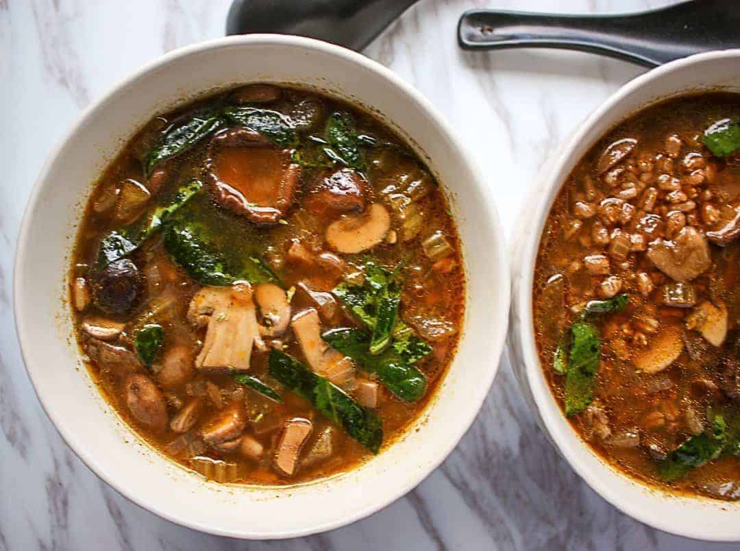 Two bowls of mushroom soup with barley