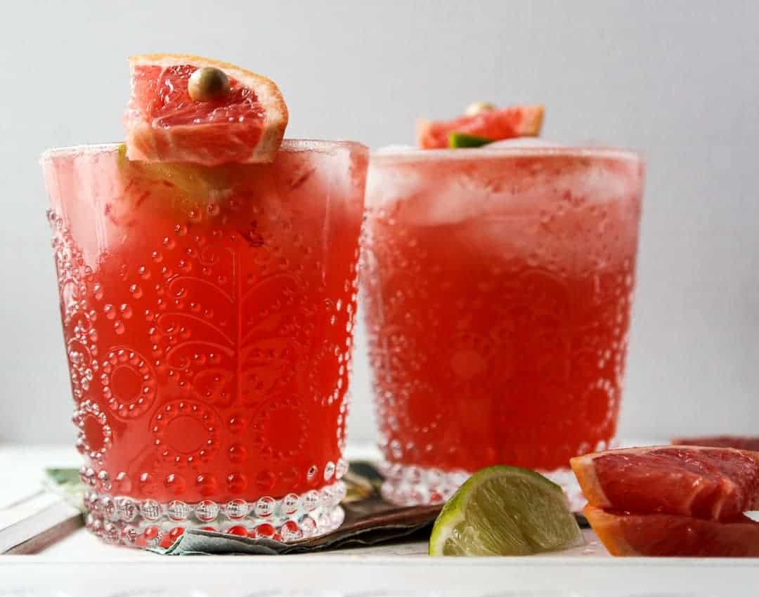 Two drinks in glasses with ice and Grapefruit juice 