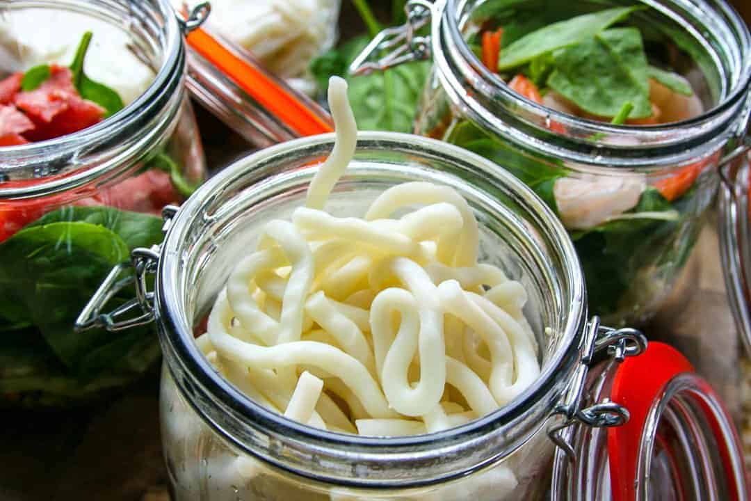 A close up of a jar of noodles