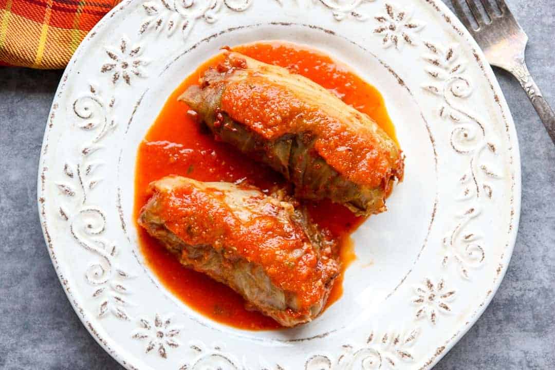 A top down view of two cabbage rolls on a plate.