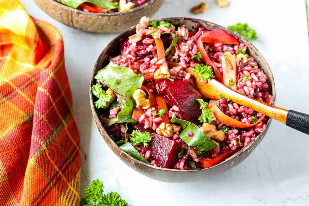 A bowl of salad with a wooden fork