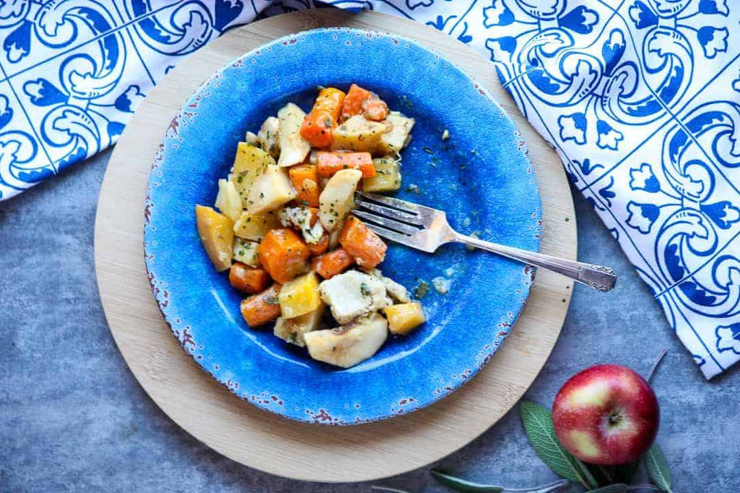 A bowl of food on a blue plate, with Apple and chicken