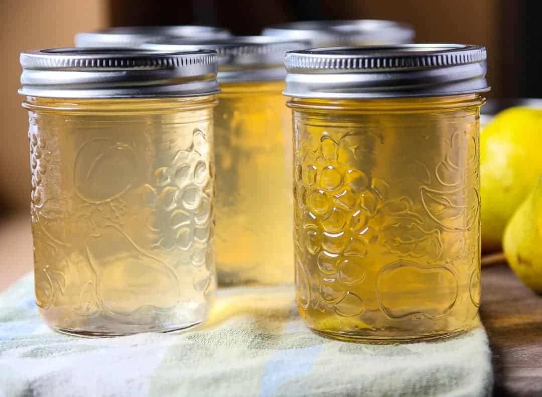 A close up of jars of jelly with lids