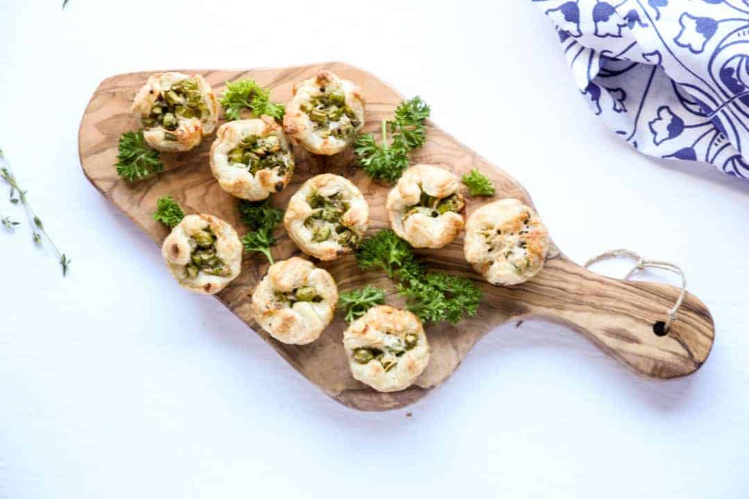 Asparagus Puff Pastry Appetizers on a wooden serving board