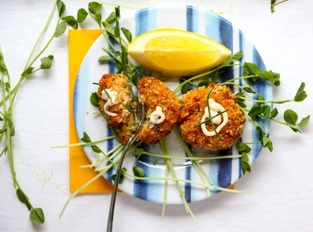 A plate of food on a table, with Crab cake and Aioli