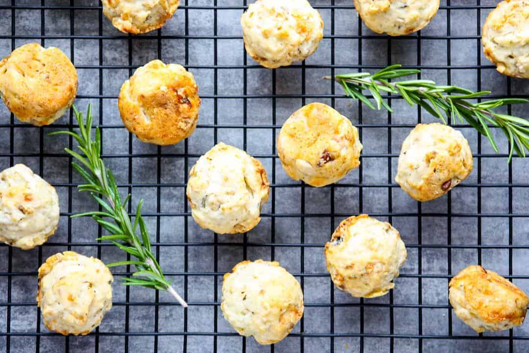 Mini muffins cooling on a wire rack on a counter