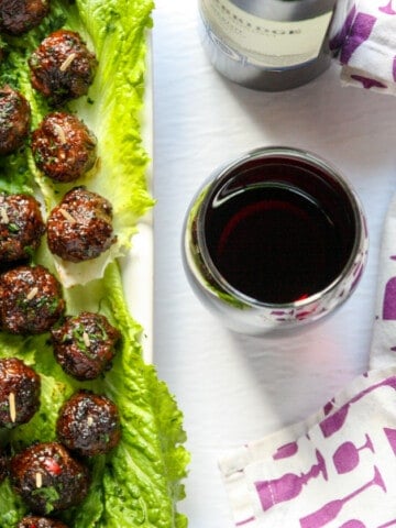 Merlot meatballs on a bed of lettuce.