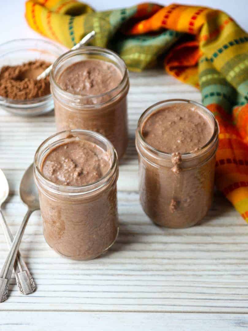 Three jars of pudding on a table