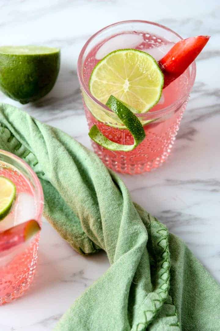 A cocktail in a glass with lime