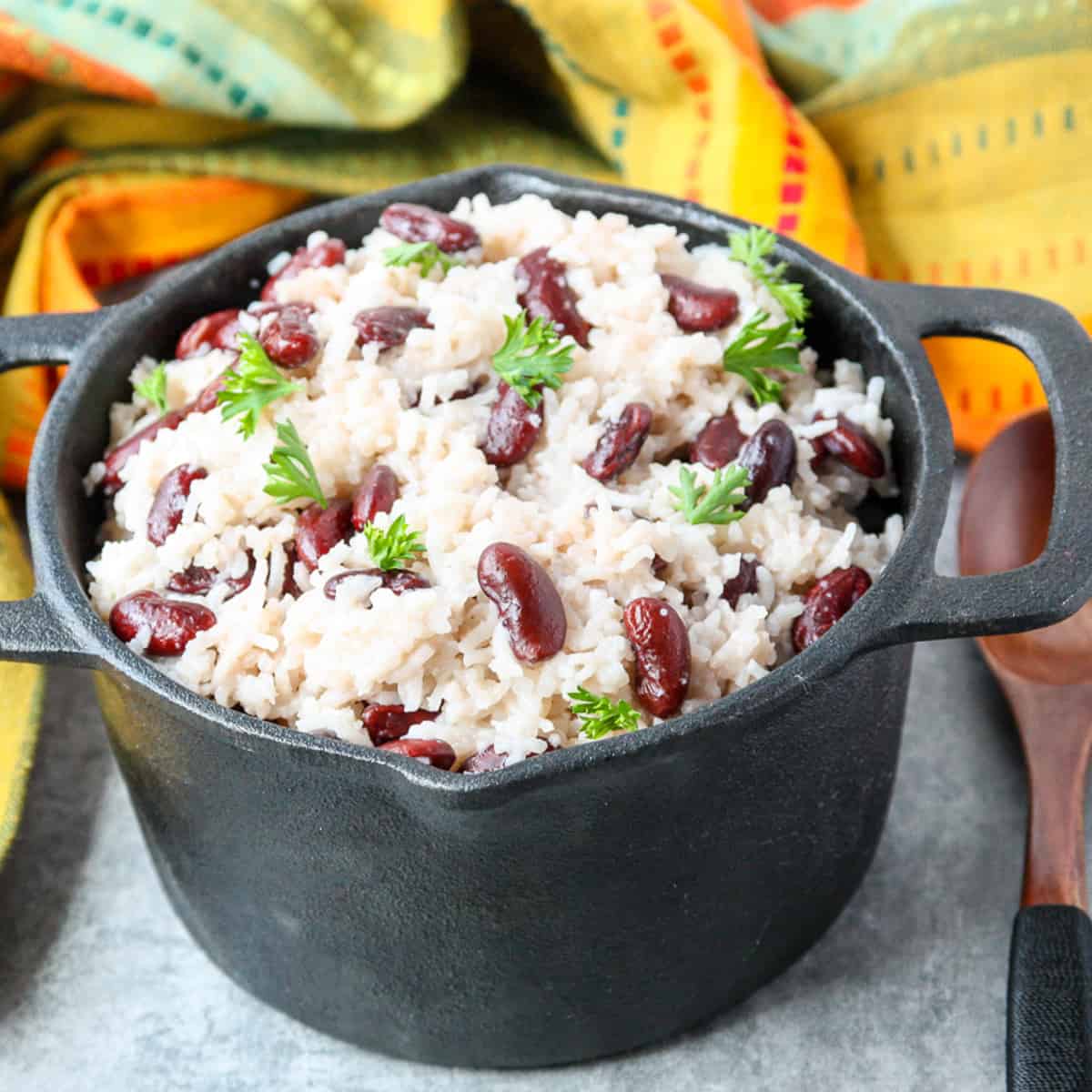 Jamaican rice and beans in a black cast iron pot.