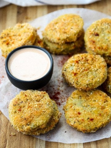 Oven Fried Green Tomatoes on parchment paper on a table