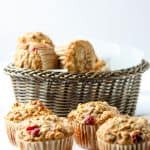 A basket of Cranberry Apple Muffins on a table