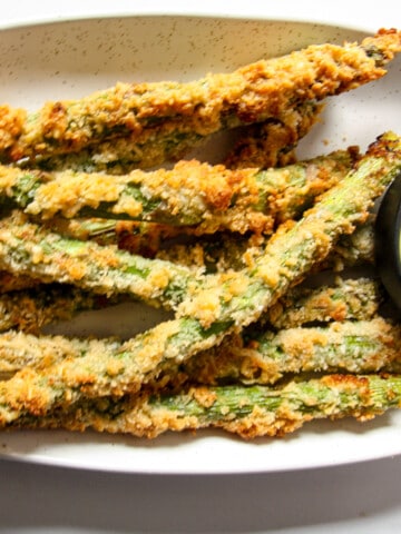A close up of fried asparagus on a plate.