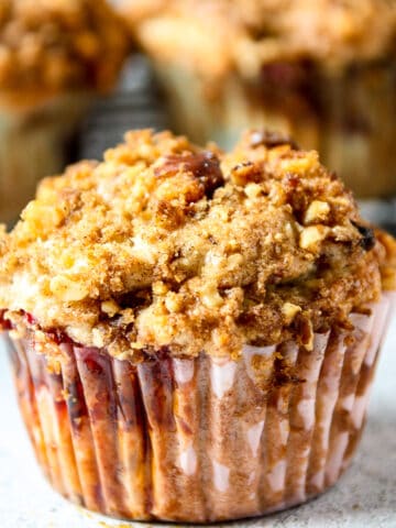 A strawberry rhubarb muffin with a streusel topping.