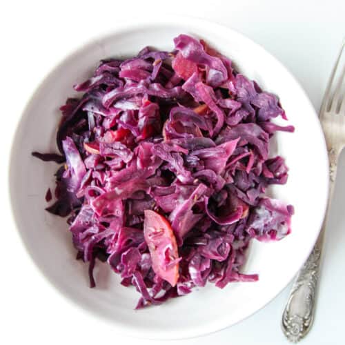 Braised red cabbage in a white bowl.