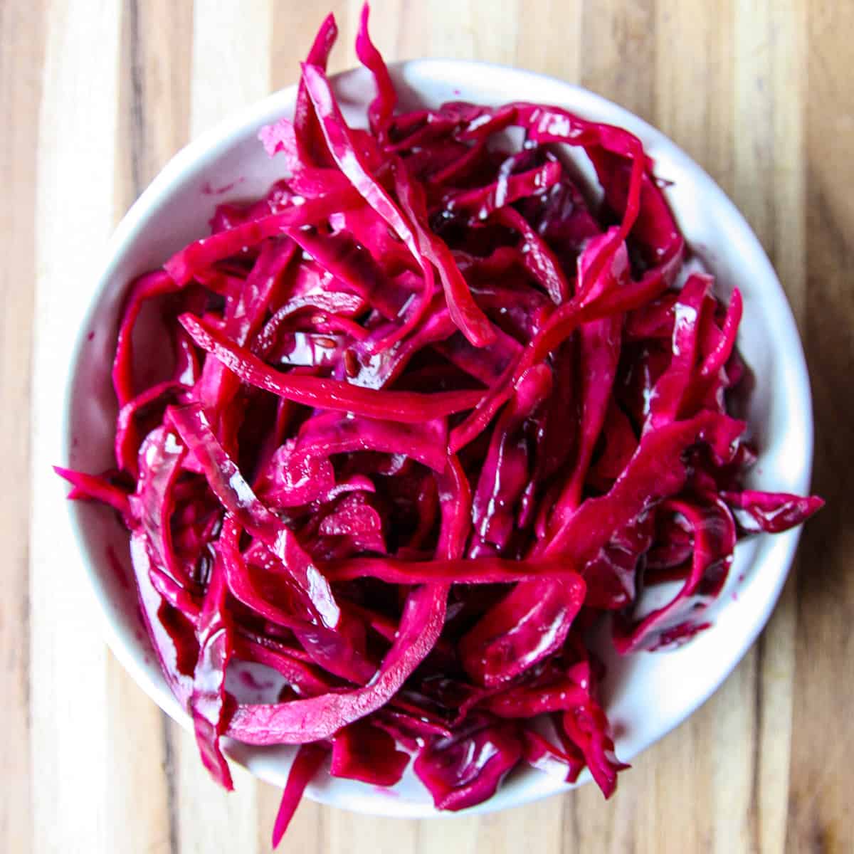 Quick pickled red cabbage in a white bowl.