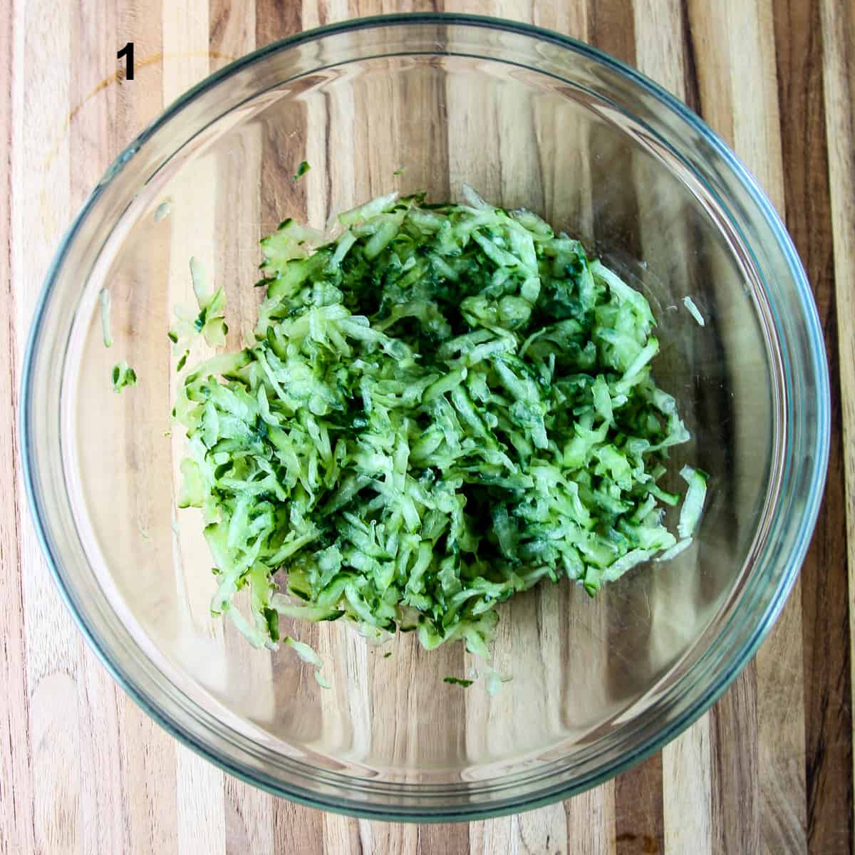 Grated cucumber in a glass bowl.