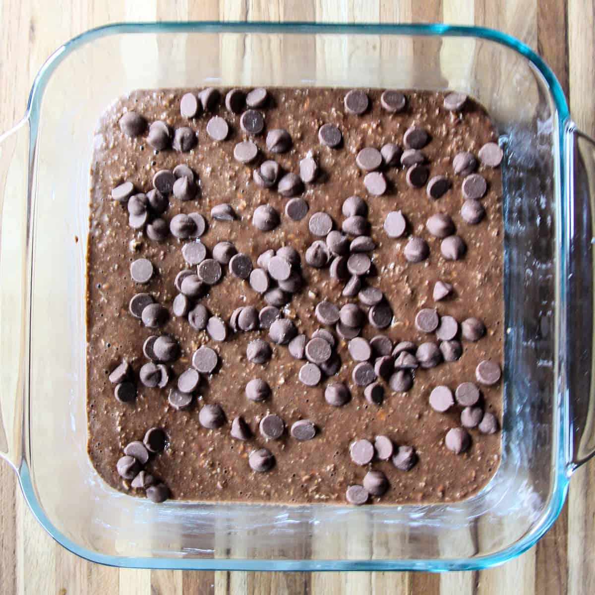 The batter spread into a glass baking dish and sprinkled with chocolate chips.
