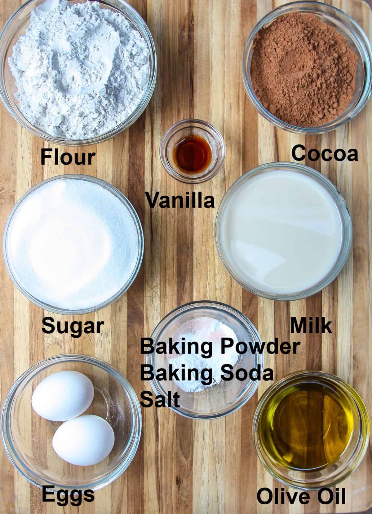 All of the ingredients needed for the air fryer cake on a wooden board.