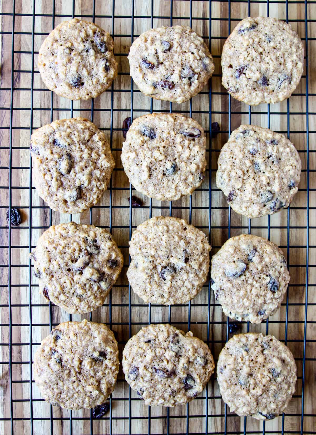 Freshly baked gluten free oatmeal raisin cookies cooling on a wire rack.