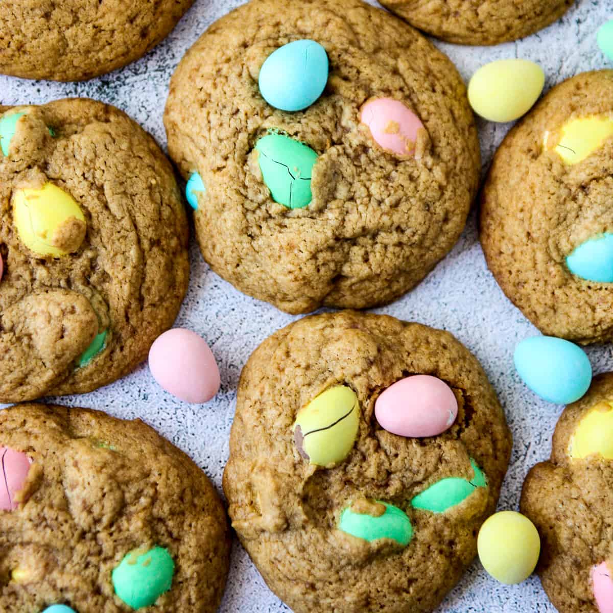 Mini egg cookies on a white surface.