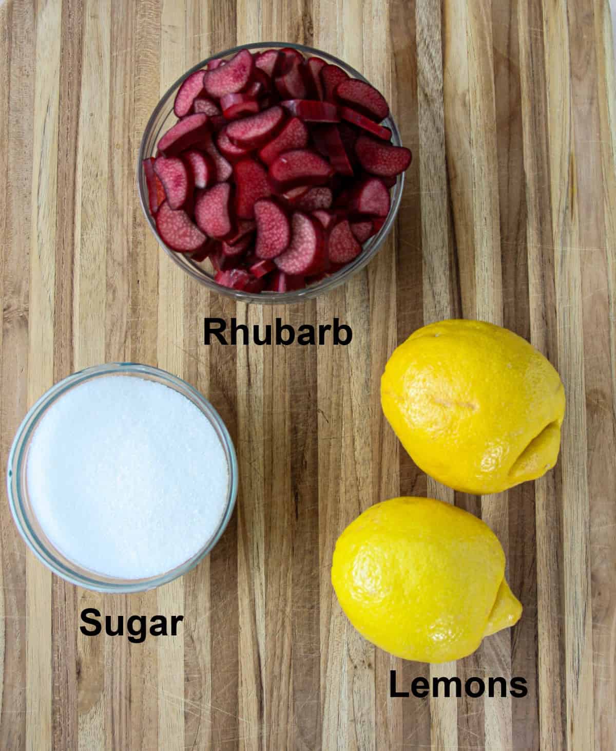 Ingredients for making rhubarbremonade on wooden planks.