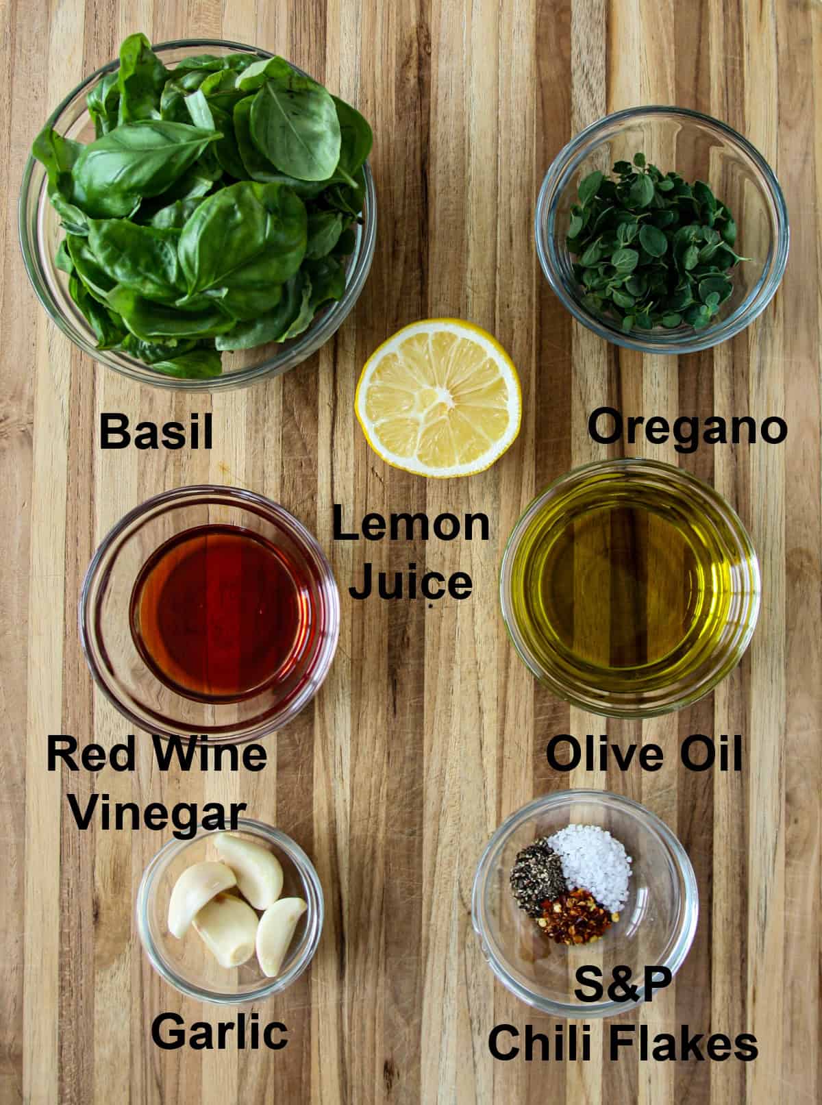 The ingredients for this recipe are in a glass bowl on a wooden board.