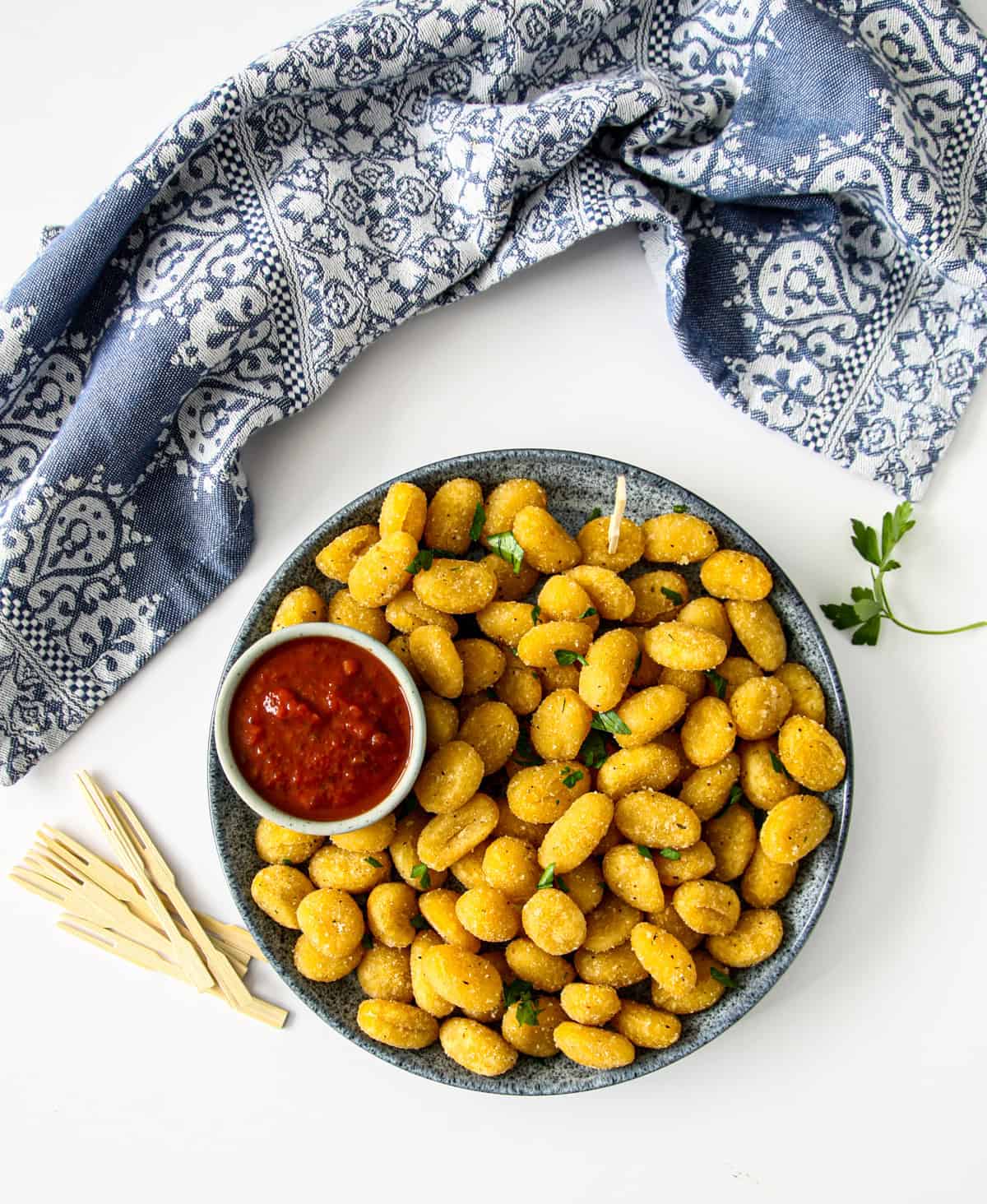 A small plate of air fryer gnocchi and tomato sauce.